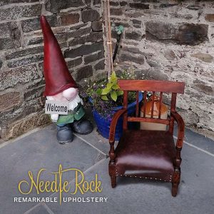 A delightful child's chair with traditional upholstery and real leather.