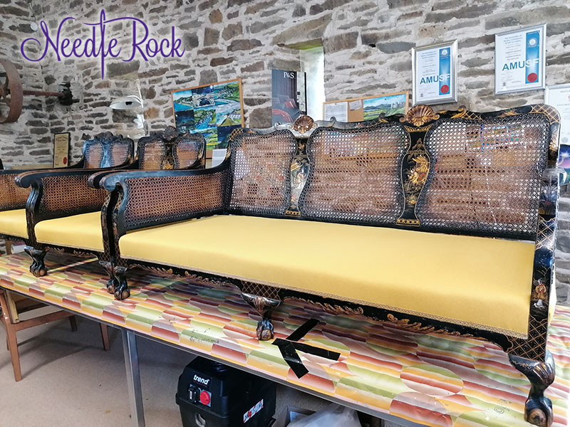 Decadent Bergère Sofa and Armchair set with black wood and golden detailing, upholstered in yellow luxury fabric.